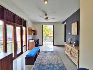 a living room with a blue bench and a table at Omeyra Residency in Ragama