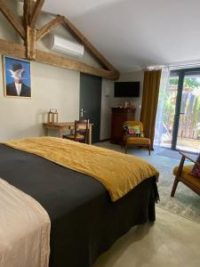 a bedroom with a bed and a table and a tv at Maison Reces in Floressas +35 photos