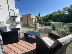a patio with two chairs and a table on a balcony at The Sapphire Suite in Luxembourg +10 photos