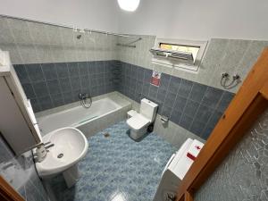 a bathroom with a sink and a toilet and a tub at Village House  +16 photos