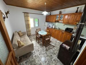 a kitchen and a living room with a couch and a table at Village House 