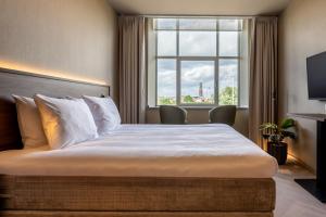 Postel nebo postele na pokoji v ubytování Hotel De Zeevaartschool