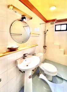 a bathroom with a sink and a toilet at Na Nue Hotel in Ho Chi Minh City