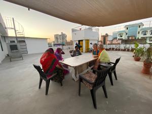 a group of people sitting around a table at Umaid Niwas Homestay in Jaipur