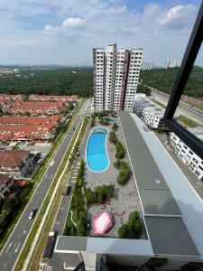 an aerial view of a building with a swimming pool at Cozy Aesthetic Apartment near KLIA Airport in Sepang
