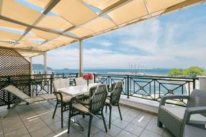 a balcony with a table and chairs and a view of the ocean at Anna Maria - Vanessa Apartments in Neo Klima +37 photos