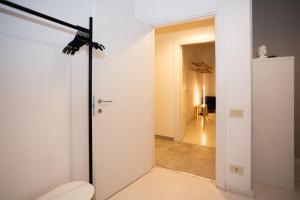 a bathroom with a toilet and a room with a hallway at Persia Collection Colosseo in Rome +54 photos