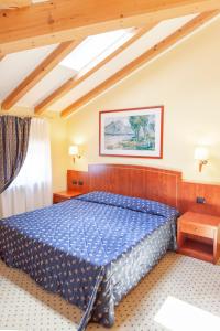 Postel nebo postele na pokoji v ubytování Hotel Olivo