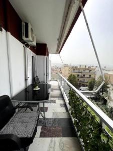 a balcony with a table and chairs on a building at City View Loft in Chania Town