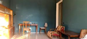a room with a table and chairs and a blue wall at Opera in Bishkek