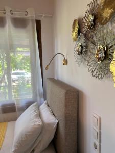 a bedroom with a couch and a window with flowers on the wall at Maniatis Garden in Achladies