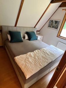 a bedroom with a large bed in a attic at Ferienhaus Nr. 40 im Ferienpark am Twistesee in Bad Arolsen