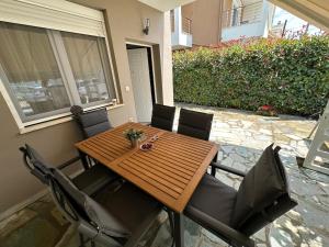a wooden table and chairs on a patio at Estia House 1-2 in Nikiti