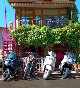 three motorcycles parked in front of a building at The Money Plant House in Nainital +3 photos