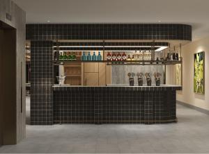 a restaurant with a black tiled counter with drinks at Hoang Kim Hotel in Vientiane