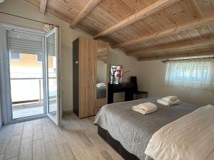 a bedroom with a bed and a large window at Estia House 1-2 in Nikiti