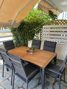 a wooden table and chairs on a patio at Estia House 1-2 in Nikiti