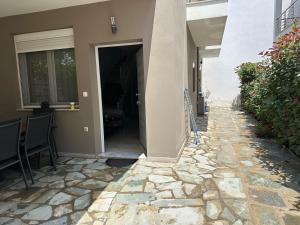 an open door to a house with a stone walkway at Estia House 1-2 in Nikiti +12 photos