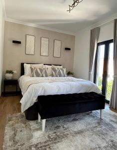 a bedroom with a large bed with white sheets and pillows at Casa Milea - Vilamoura Marina in Quarteira