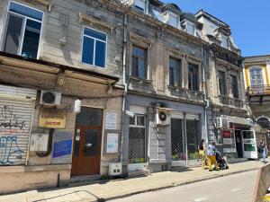 an old building on the side of a street at habitat Heart of Ruse Apartment in Ruse