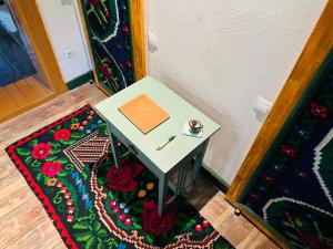 a small table with a book and a pen on a rug at Bed & Wine Transylvania in Nemşa +25 photos