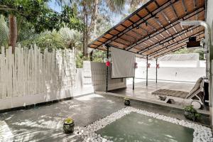DenkanikotaにあるCasa Bella - 1 BHK Luxury Villa Bangaloreの柵とテーブルとステージのあるパティオ