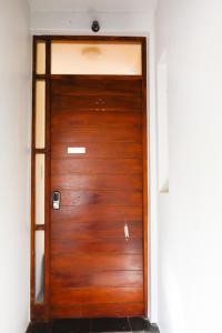 a wooden door in a white room with at Golf Estate Living 1BR Apartment in Jackal Creek in Roodepoort