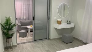 a bathroom with a shower and a sink and a mirror at Dionis House in Shkodër