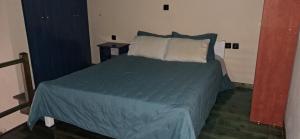 a bedroom with a bed with blue sheets and pillows at ABC Studios B in Lamía