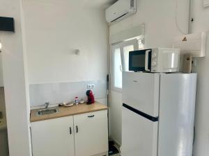 a kitchen with a white refrigerator and a microwave at Apartamento B San Jose de los Llanos in San Jose De Los Llanos