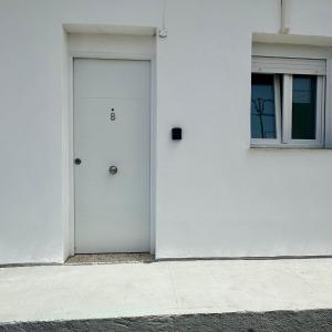 a white door on the side of a building at Apartamento B San Jose de los Llanos in San Jose De Los Llanos