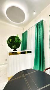 a room with a table and a green curtain at New Green Horse Hotel in Cotonou +84 photos