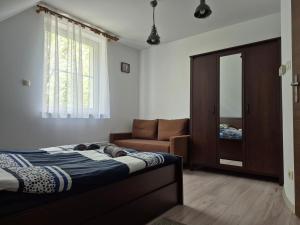 Posteľ alebo postele v izbe v ubytovaní Domek na Mazurach-Piasutno