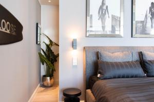 a bedroom with a bed and two pictures on the wall at Ferienwohnung Hang Loose Scharbeutz in Scharbeutz +26 photos