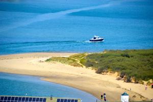 a boat in the water next to a beach at The Pilot Boat Inn, Isle of Wight in Bembridge