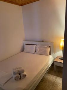 a bedroom with a bed with towels on it at Samothraki Therma Noula Rooms in Samothraki