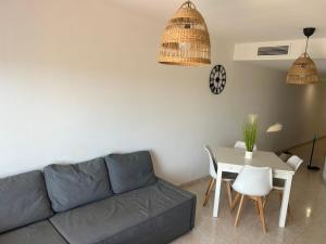 a living room with a couch and a table at Apartamento vistas al mar in Sant Carles de la Ràpita