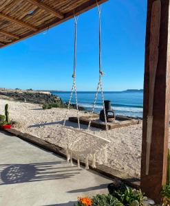 a swing on a beach with the ocean in the background at Frente al Mar - Punta de Choros Casa La Changa in La Higuera