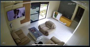 an overhead view of a living room with couches and a tv at Eliora Hotel, Tororo in Tororo