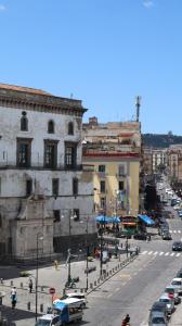 a busy city street with cars and a building at PORTACAPUANA Guest House in Naples