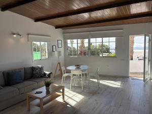a living room with a couch and a table at Casa Rural Encantadora Con Terraza Privada in Arona