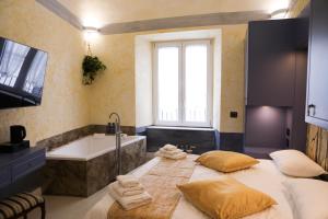 a bathroom with a large bed with towels on it at Odeon Neapolis - Historic Suites in Roman Theater in Naples