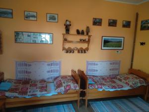 a bedroom with two beds and pictures on the wall at Apartmán U Bartoloměje in Verneřice +18 photos