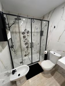 a bathroom with a shower and a toilet and a sink at Costa Marina III - Vistas inmejorables in El Borseral