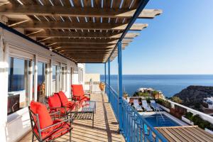 a balcony with chairs and a view of the ocean at Blue House I Pool I Art I BBQ I Peace I Relax in Almería