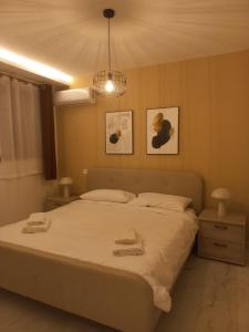 a bedroom with a bed with two towels on it at Hal Wardija Resort Apartments in Qala