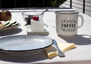 a table with a plate and a cup of coffee at Turistična kmetija Weiss in Miklavž pri Taboru