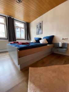 a bedroom with a large bed with blue sheets at Münzbach Ferienzimmer in Bacharach