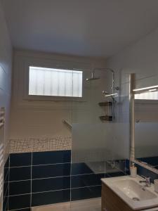 a bathroom with a glass shower and a sink at F3 Meublé Rdc Amélie-les-Bains in Amélie-les-Bains-Palalda +10 photos