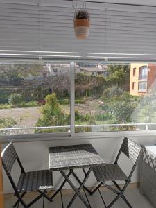 a table and two chairs in front of a window at F3 Meublé Rdc Amélie-les-Bains in Amélie-les-Bains-Palalda